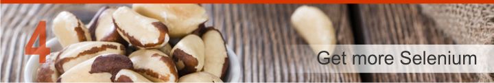 Brazil nuts in a bowl with other nuts on a table